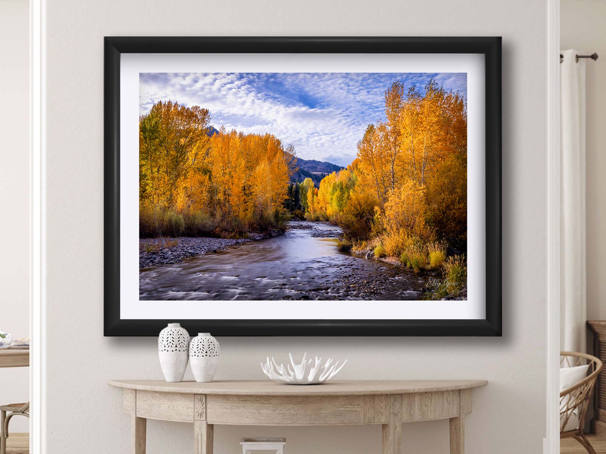 Aspen trees in the fall along Wood River in Sun Valley Idaho fine art print in black frame styled above a table in a bright entryway