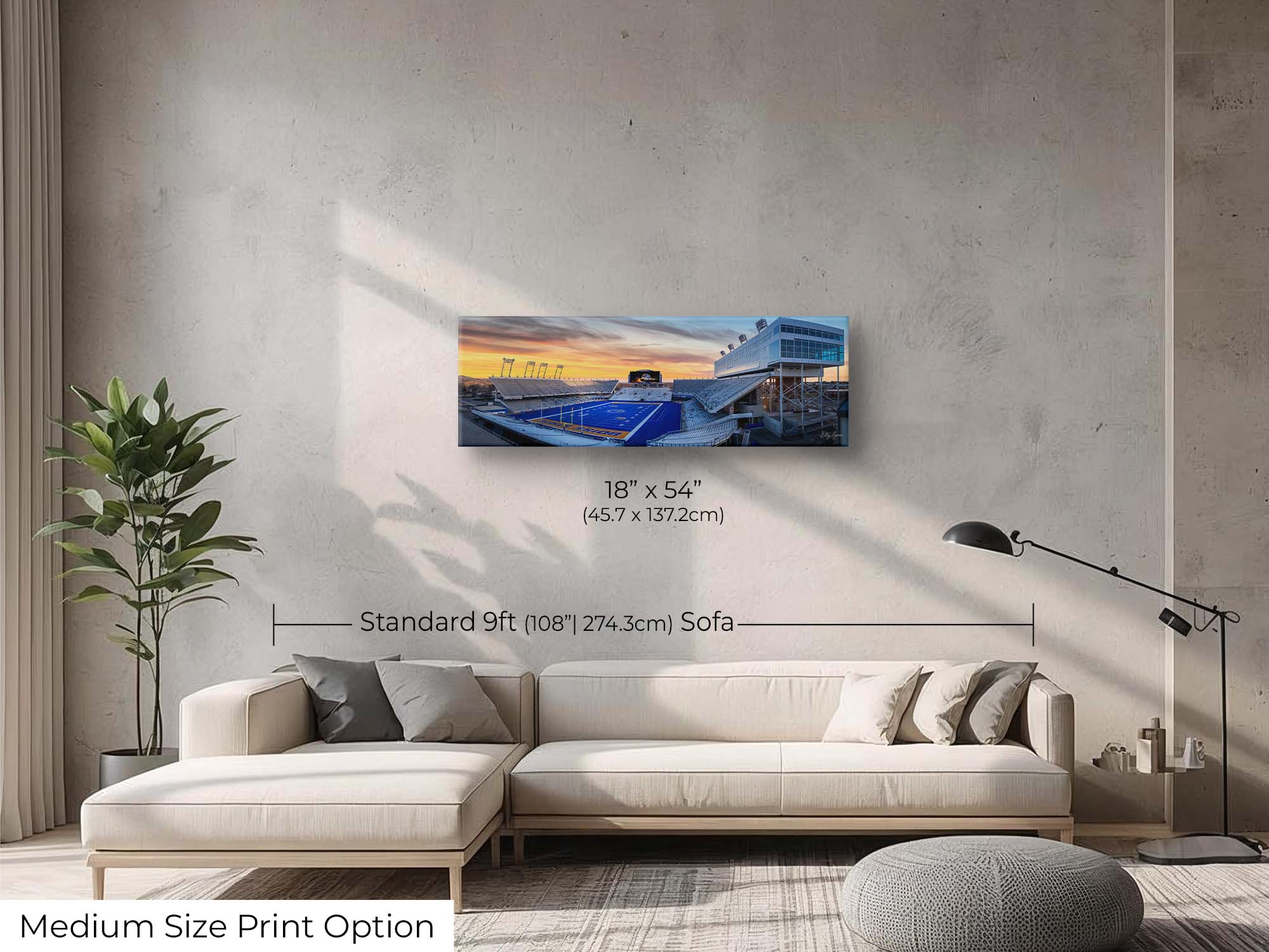 BSU Broncos stadium, blue turf sunset fine art print wall art size mockup showing an 18x54 inch print above a nine foot sofa