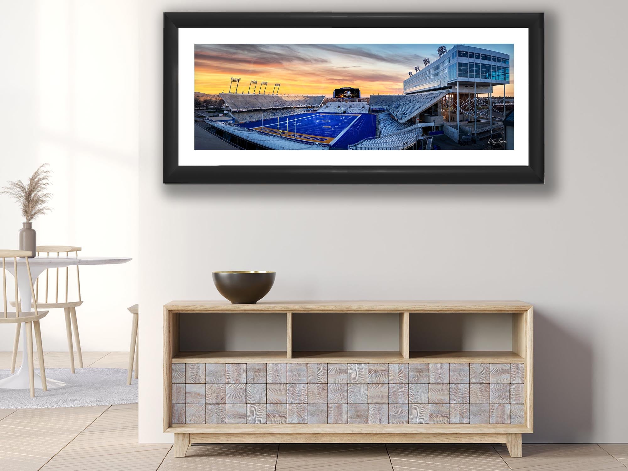 BSU Broncos stadium, blue turf sunset fine art print in black frame styled above a console in a bright dining room