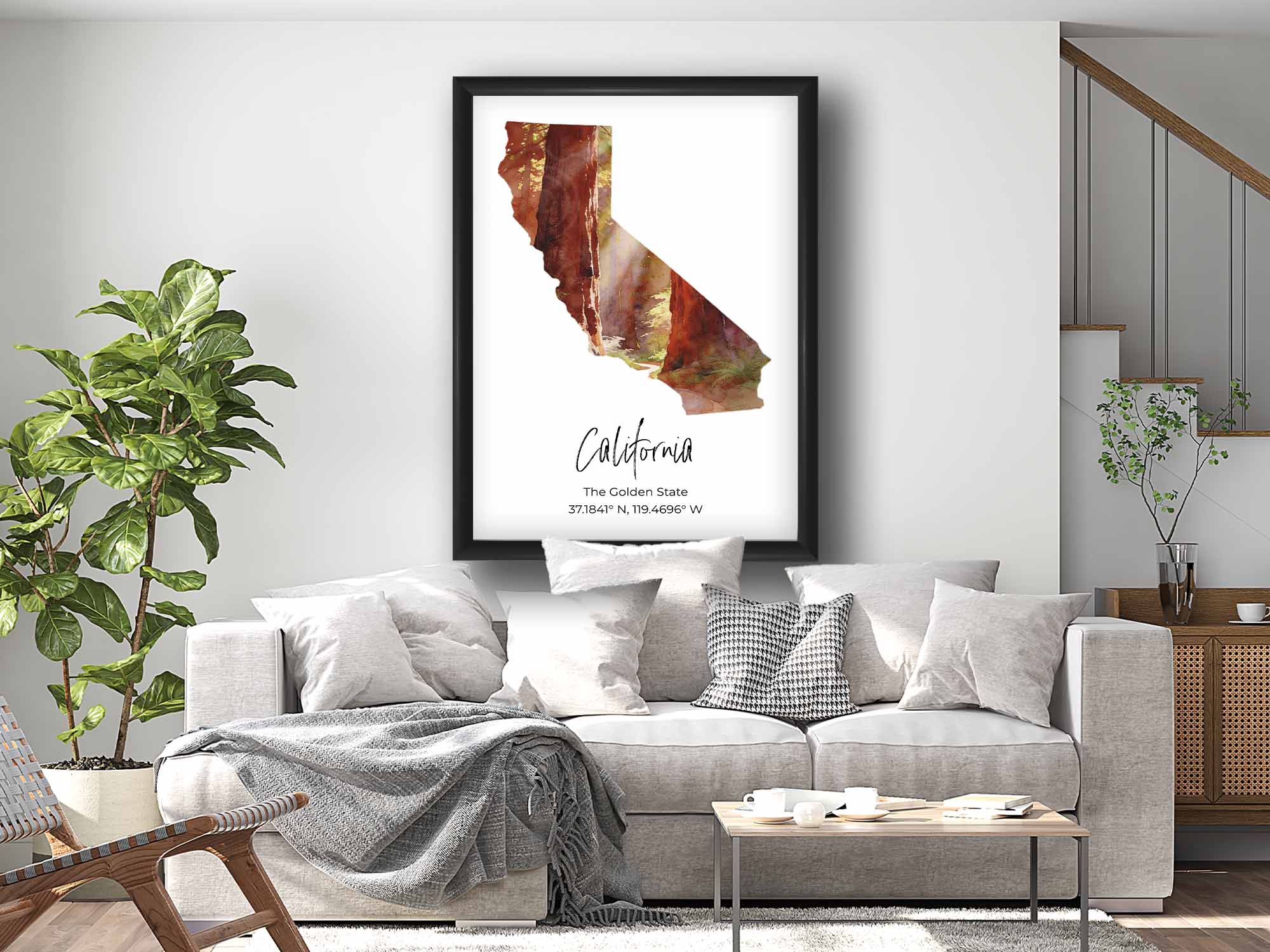 California watercolor state map with redwood forest wall art print in black frame styled above a sofa in a bright living room