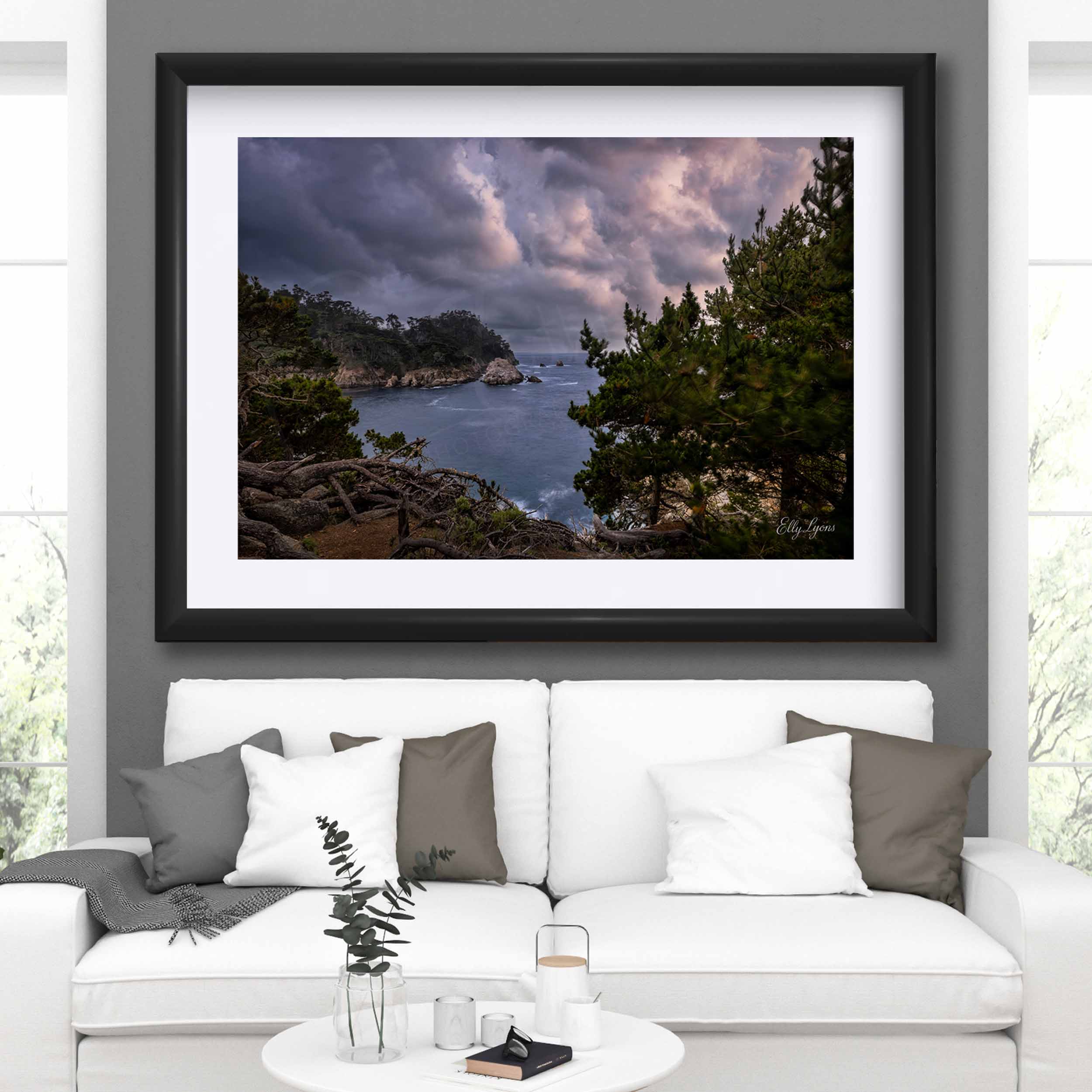 California Carmel Point Lobos beach sunset fine art print in black frame styled above a sofa in a bright living room