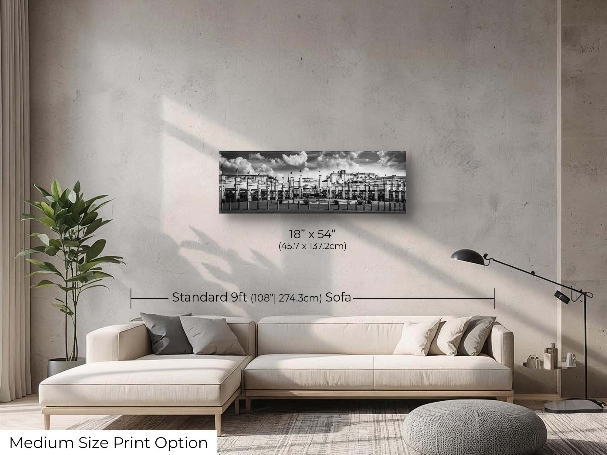Churchill Downs panoramic black and white fine art print wall art size mockup showing an 18x54 inch print above a nine foot sofa 