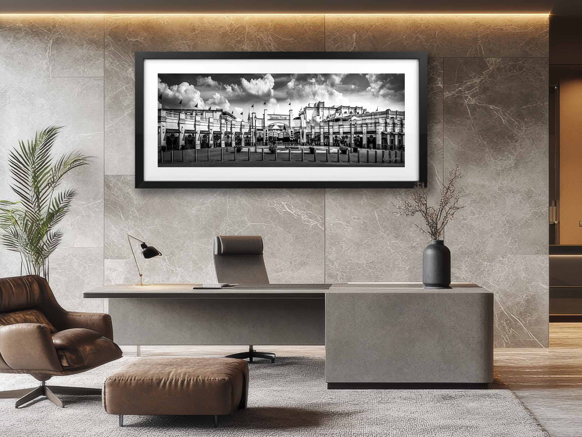 Churchill Downs panoramic black and white fine art print in black frame styled above a desk and chair in a bright office