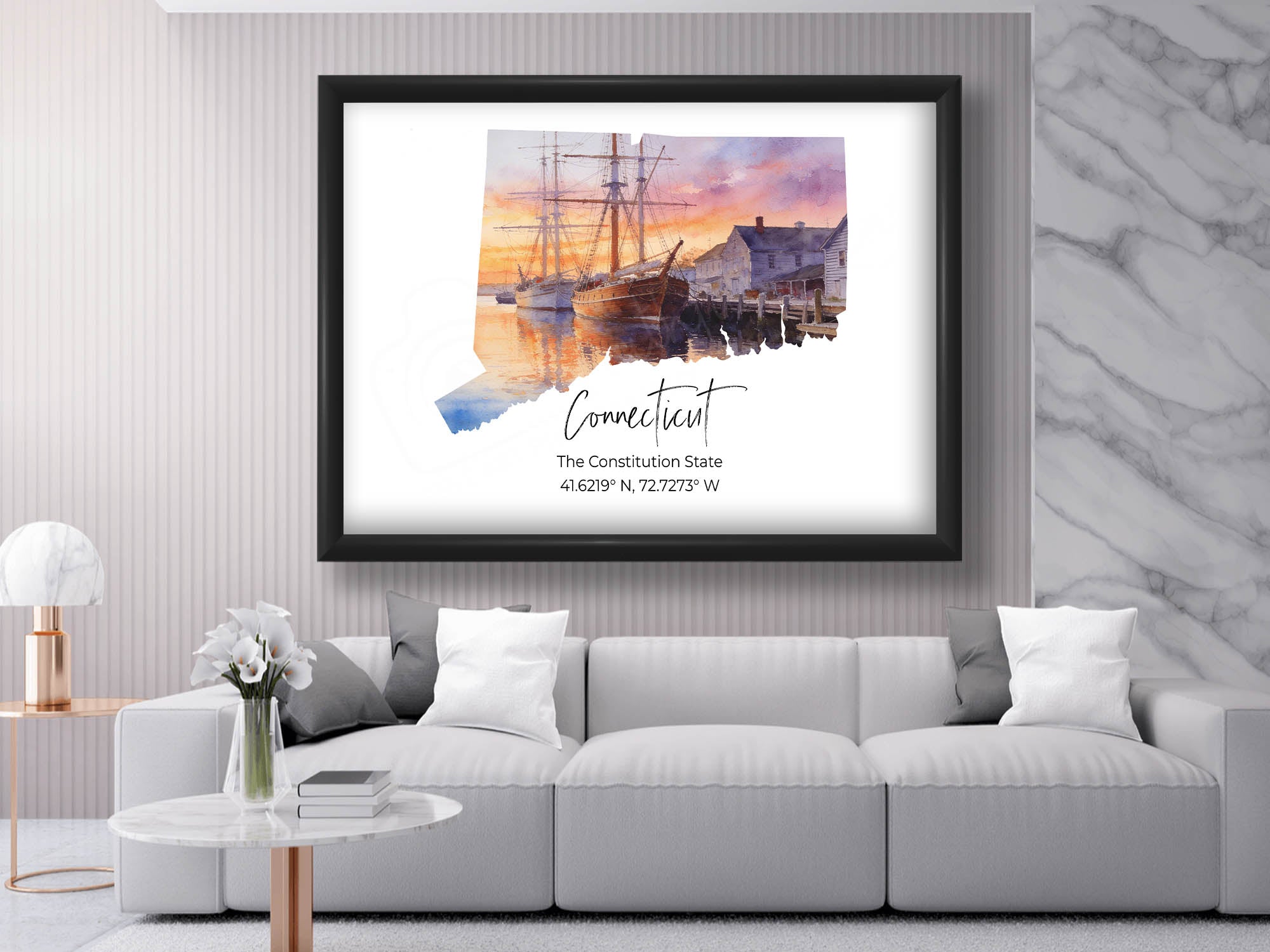 Connecticut watercolor state map with mystic seaport wall art print in black frame styled above a sofa in a bright living room