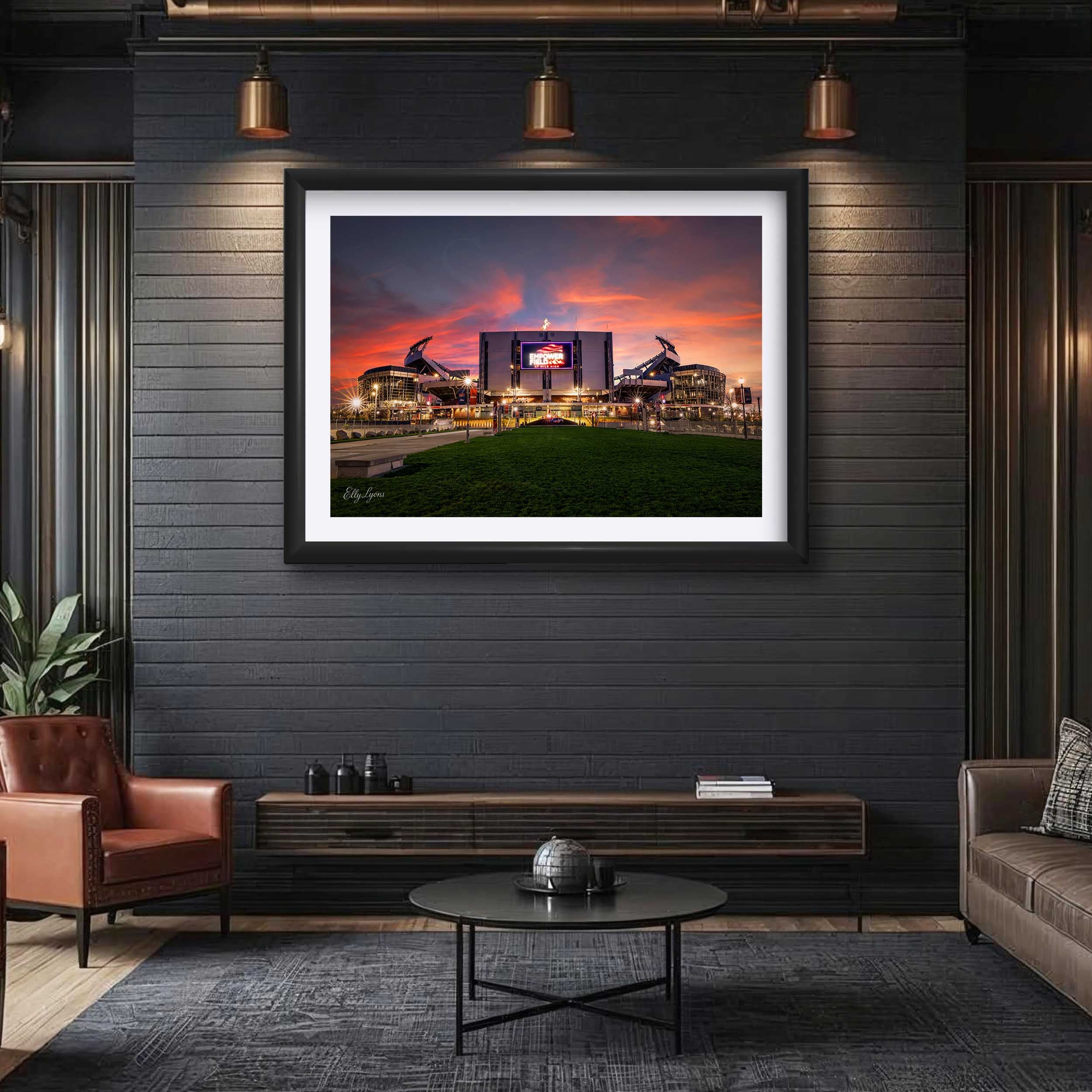 Empower Field Denver Broncos sunset fine art print in black frame styled above a console in a man cave