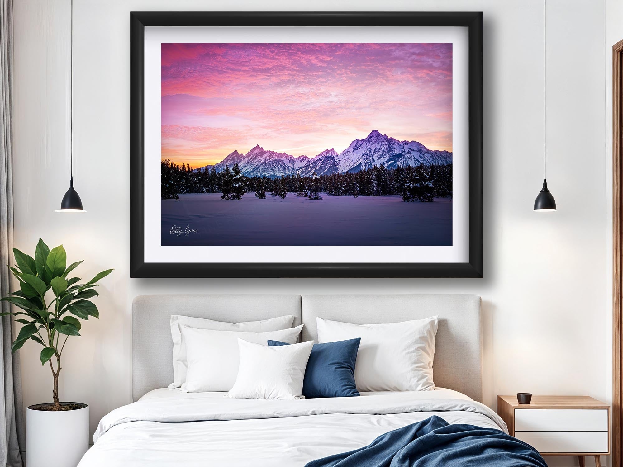 Grand Teton National Park winter sunset fine art print in black frame styled above a bed in a bright bedroom