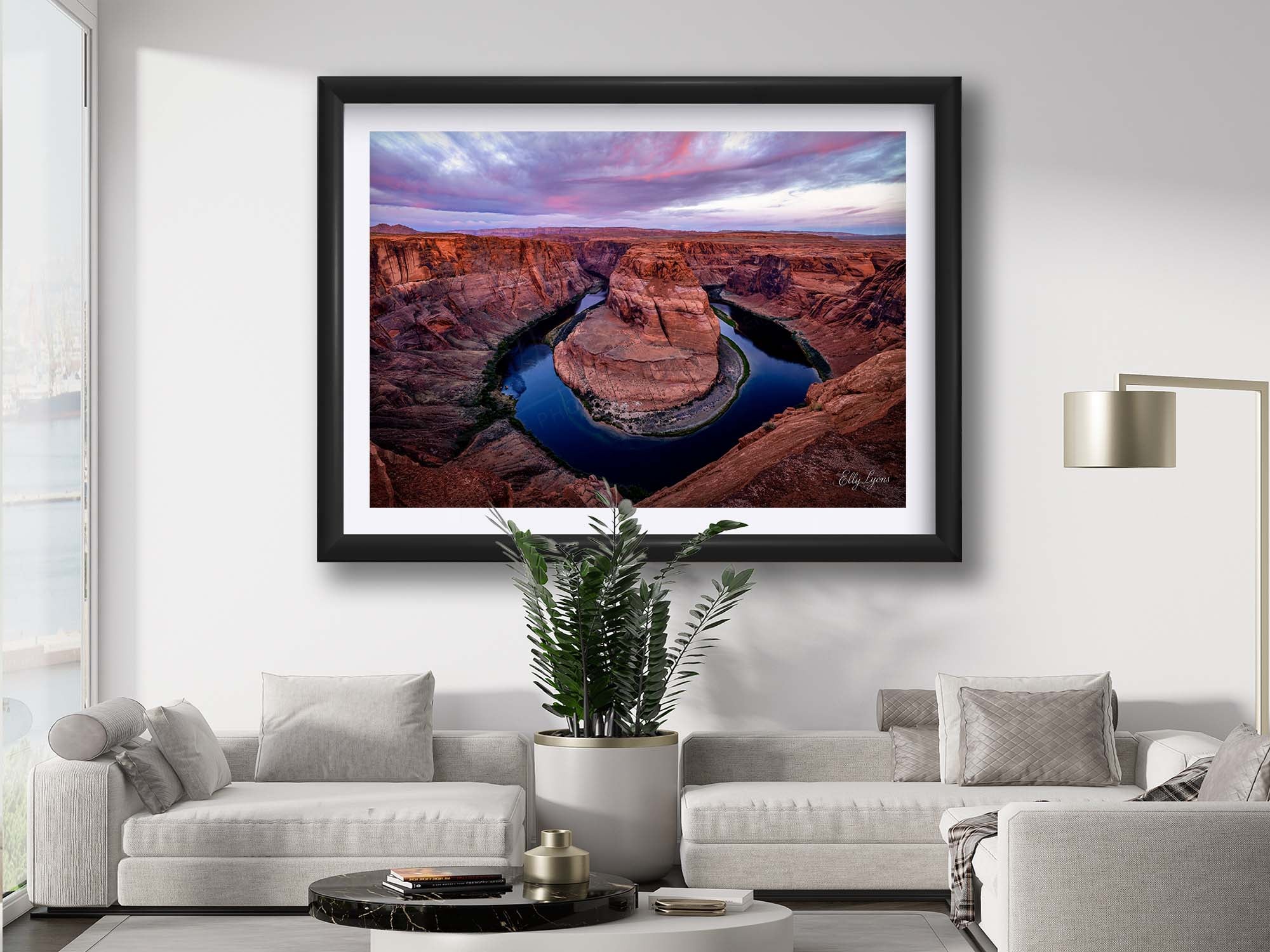 Horseshoe Bend Arizona sunrise fine art print in black frame styled above a sofa in a bright living room