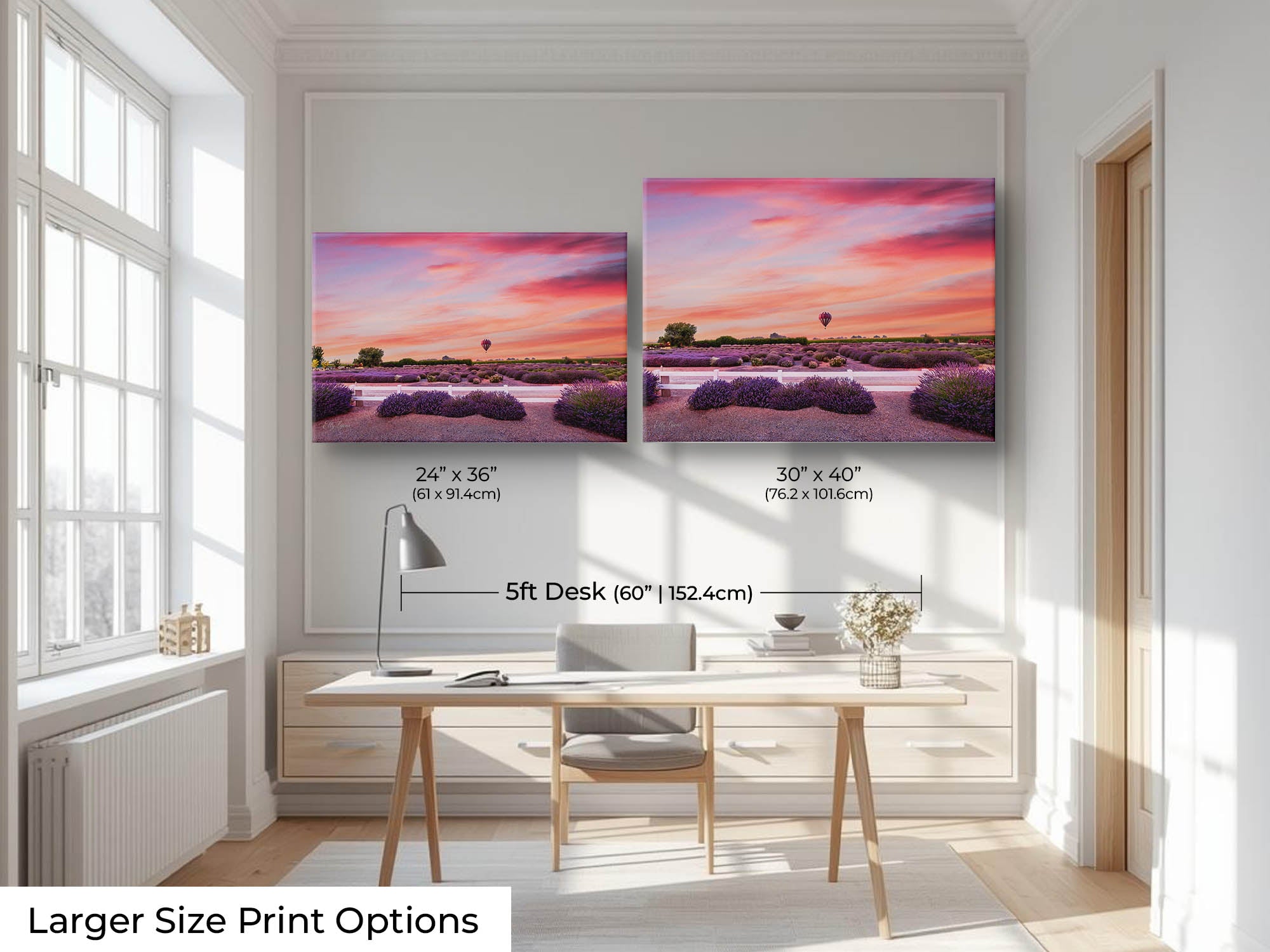 A hot air balloon over a lavender field during sunset fine art print wall art size mockup showing 24x36 and 30x40 inch prints above a five foot office desk and chair in a bright office 
