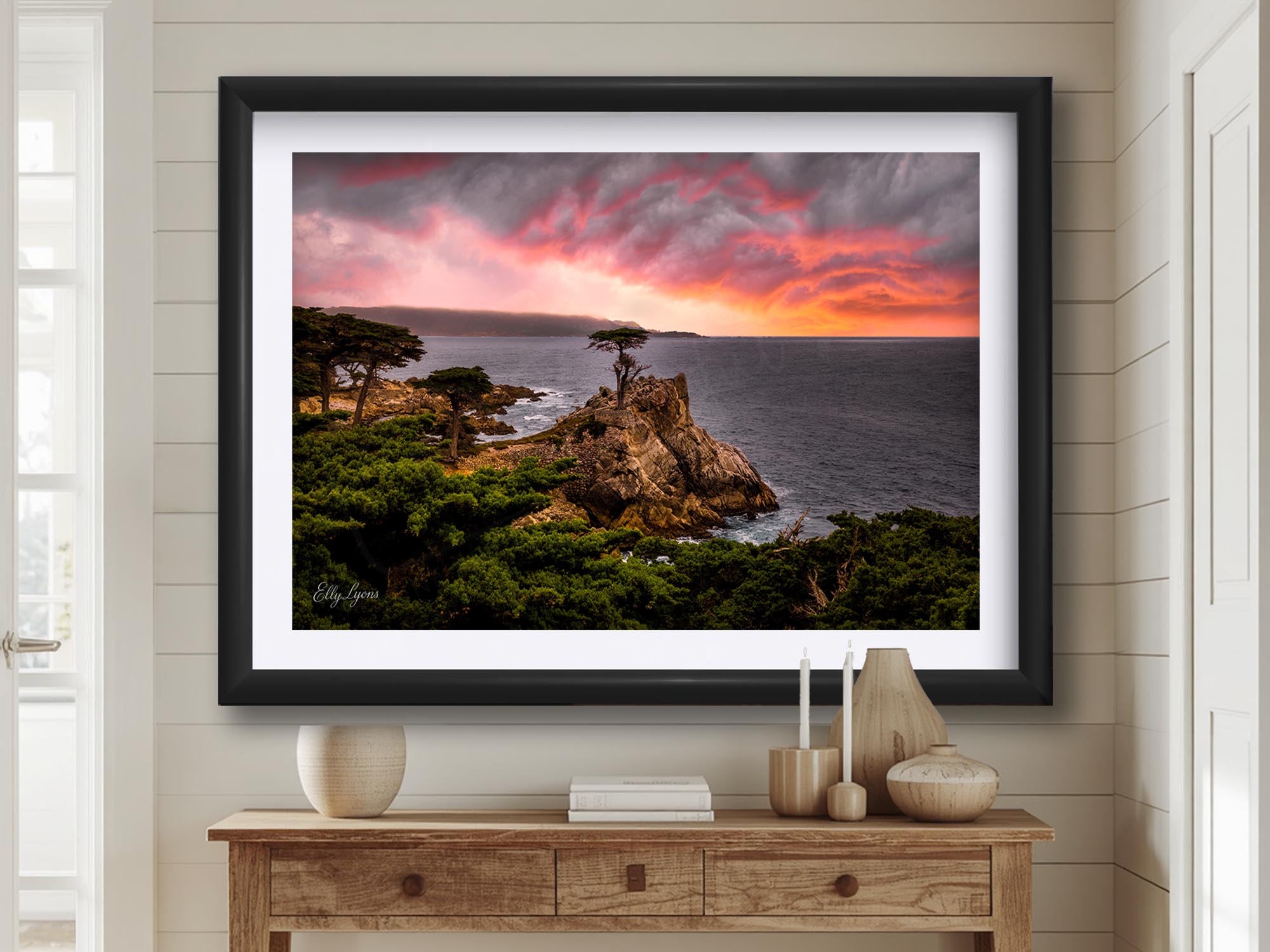 Lone Cypress sunset at Carmel by the Sea in California fine art print in black frame styled above a wooden table in a bright entryway
