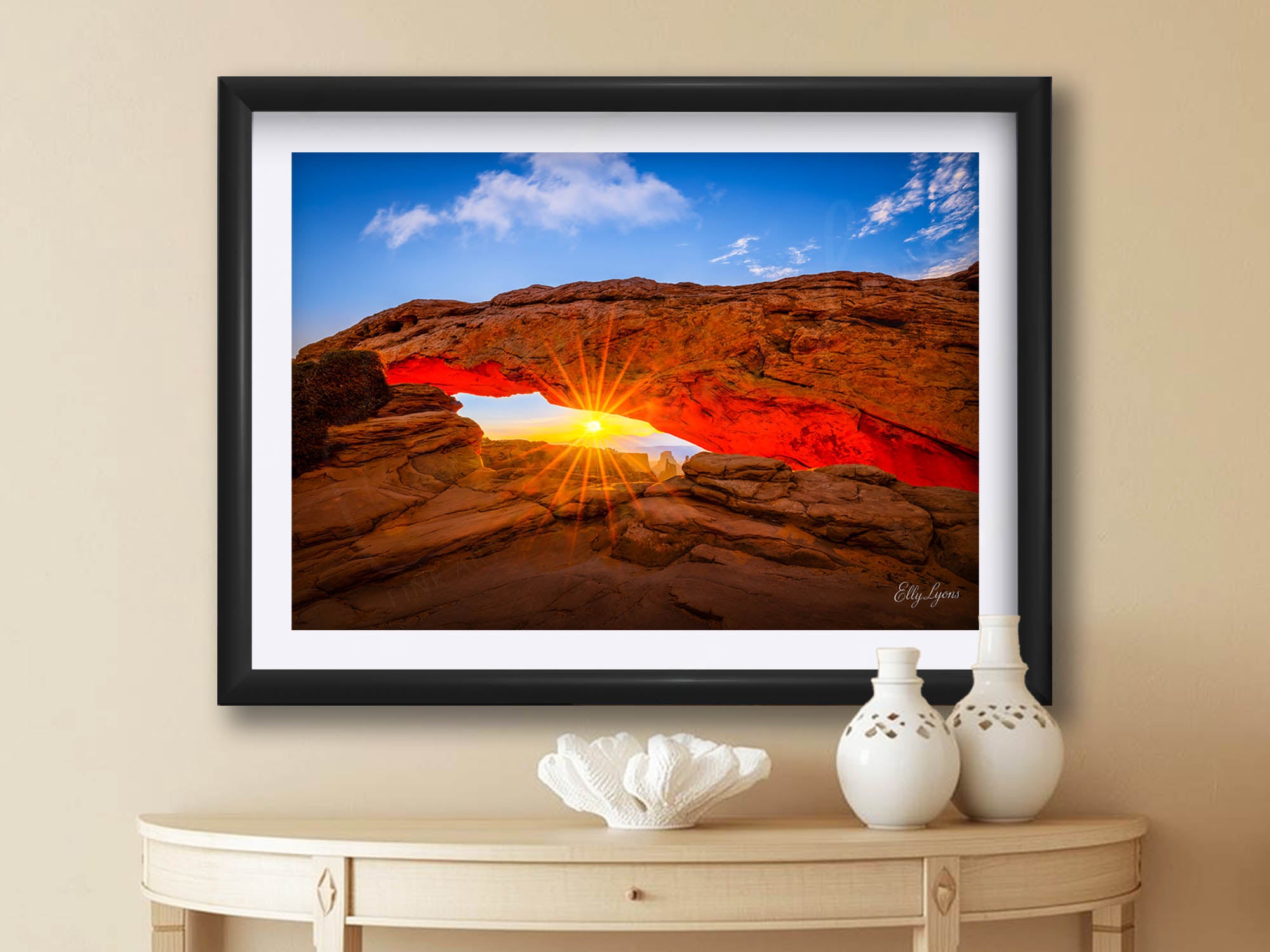 Mesa Arch at Canyonlands National Park sunrise fine art print in black frame styled above a table in a bright entryway
