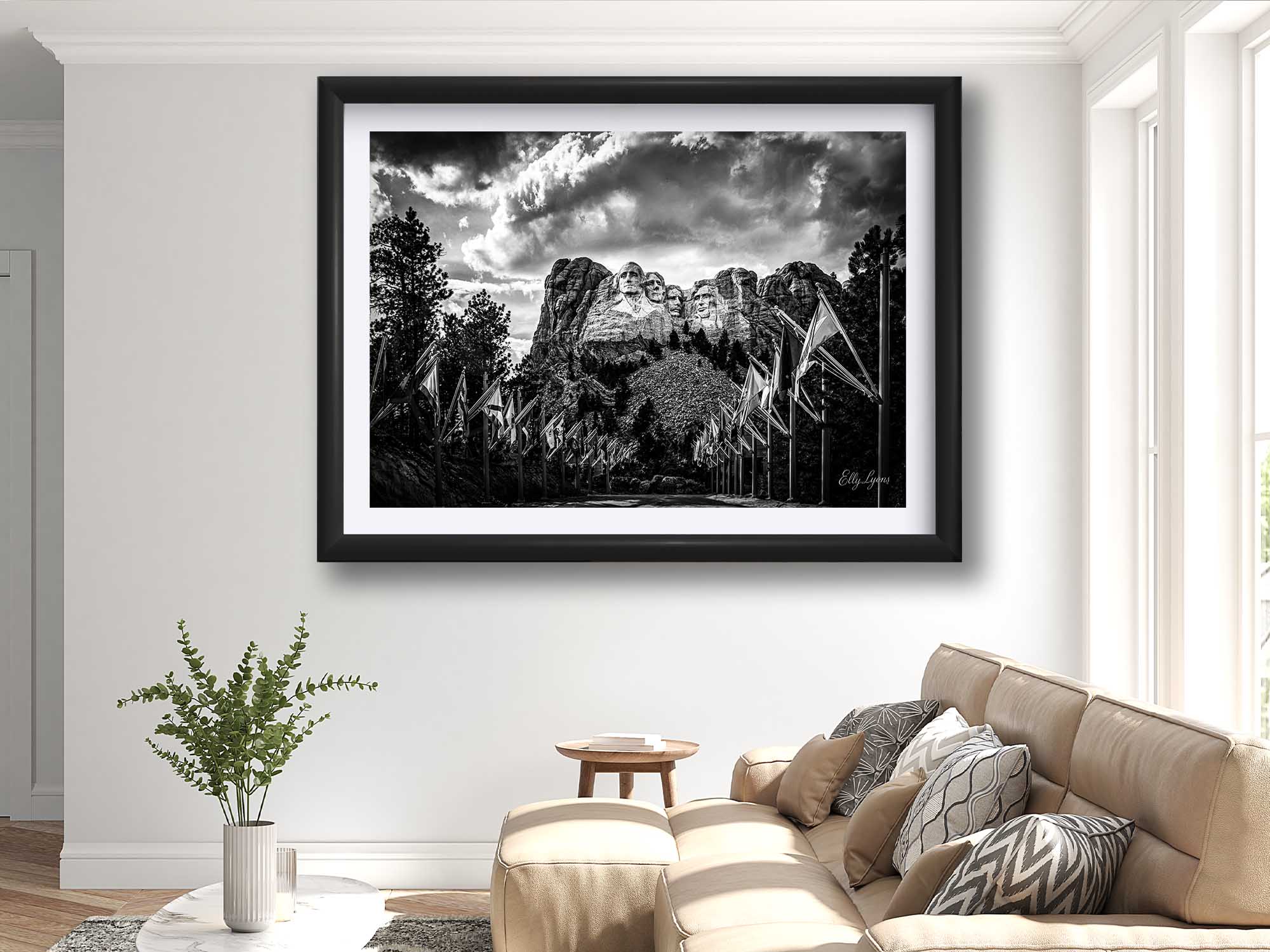 Mount Rushmore black and white fine art print in black frame styled above a sofa in a bright living room