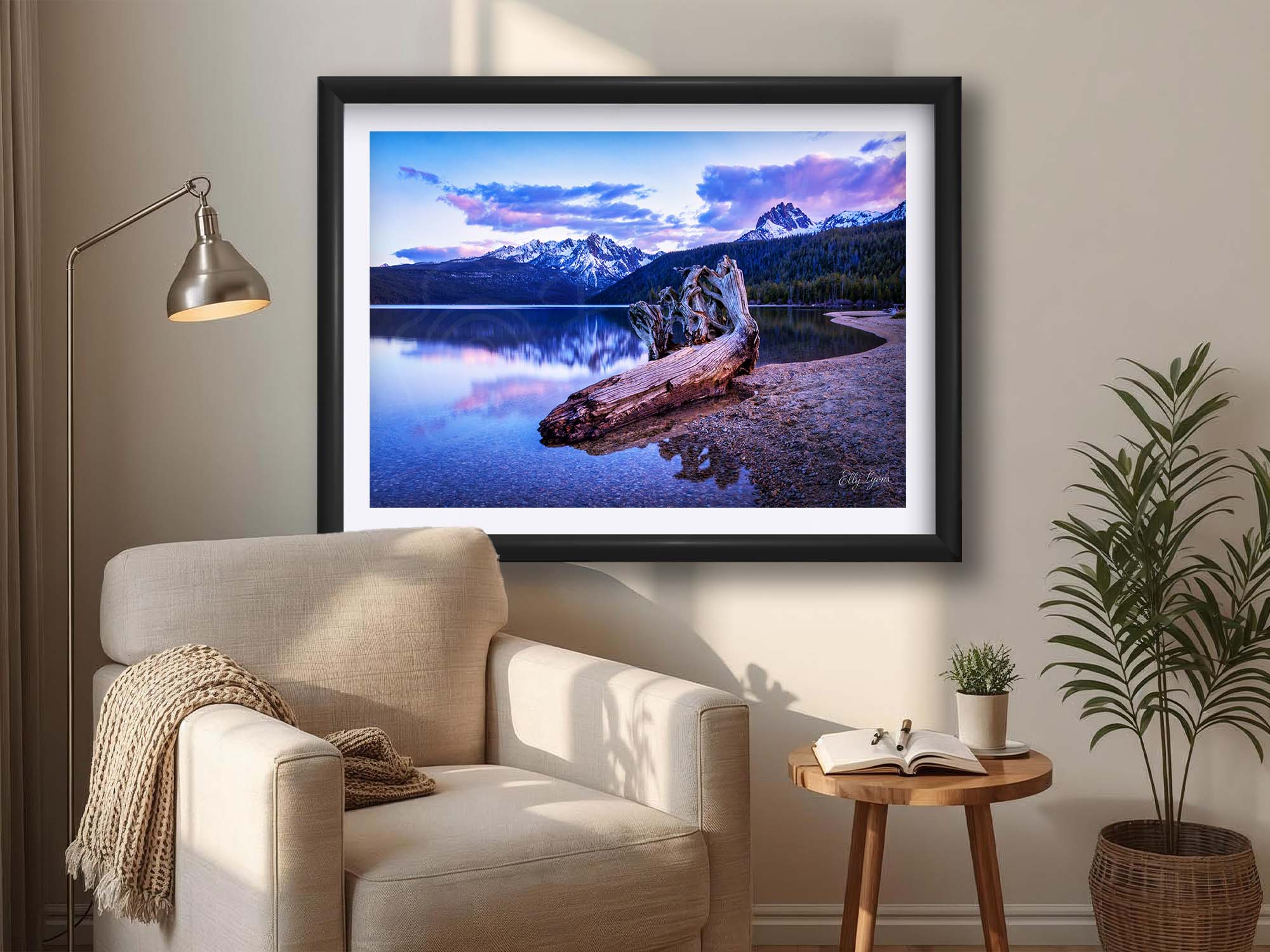 Sawtooth mountains at Redfish Lake in Idaho at sunset fine art print in black frame styled above a reading chair in a bright reading nook