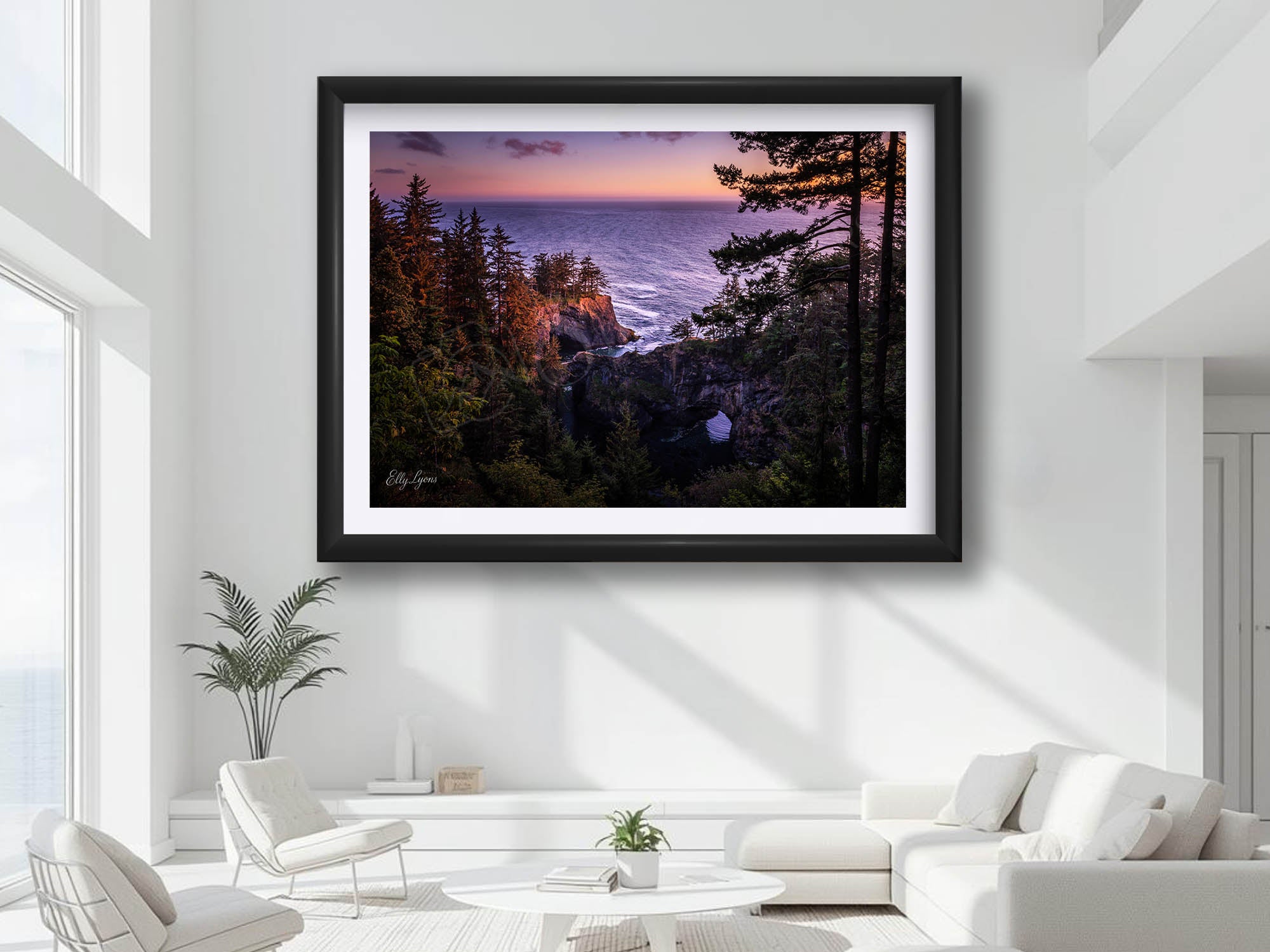 Brookings Oregon natural bridges sunset fine art print in black frame styled above a sofa in a bright living room