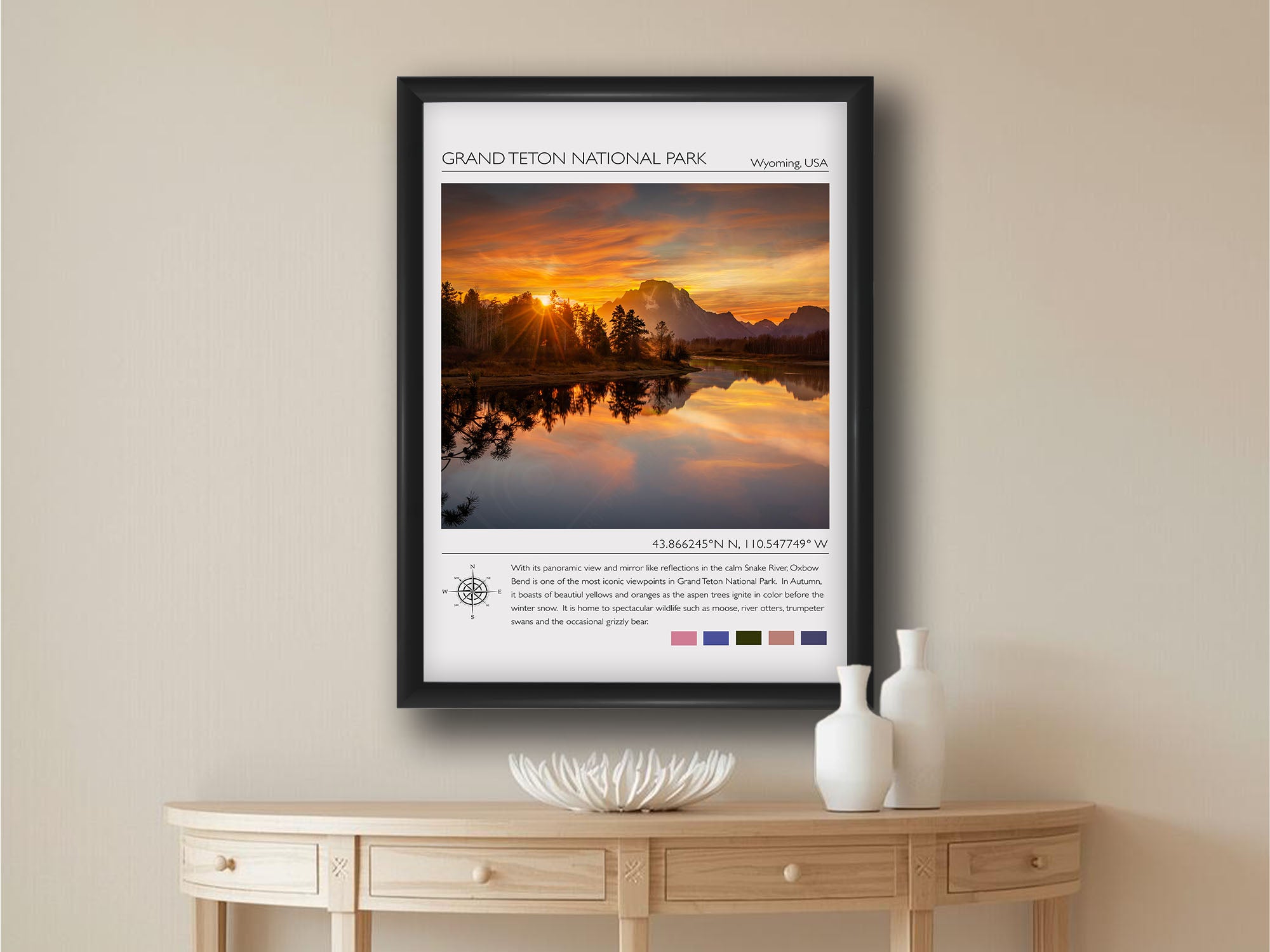 Grand Teton National Park travel poster featuring an Oxbow Bend sunset photograph and photo inspired color palette in black frame styled above a wooden table in a bright entryway