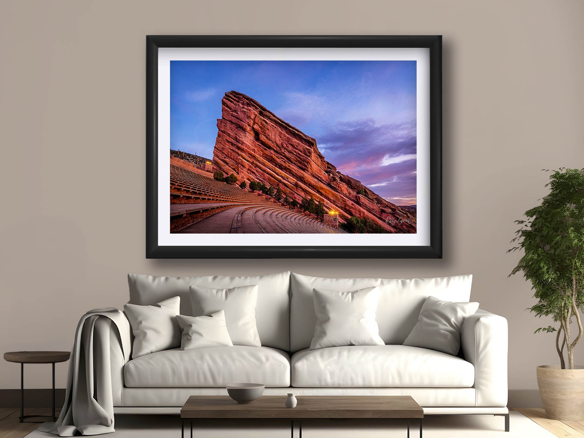 Red Rocks Amphitheater Colorado sunrise fine art print in black frame styled above a sofa in a bright living room