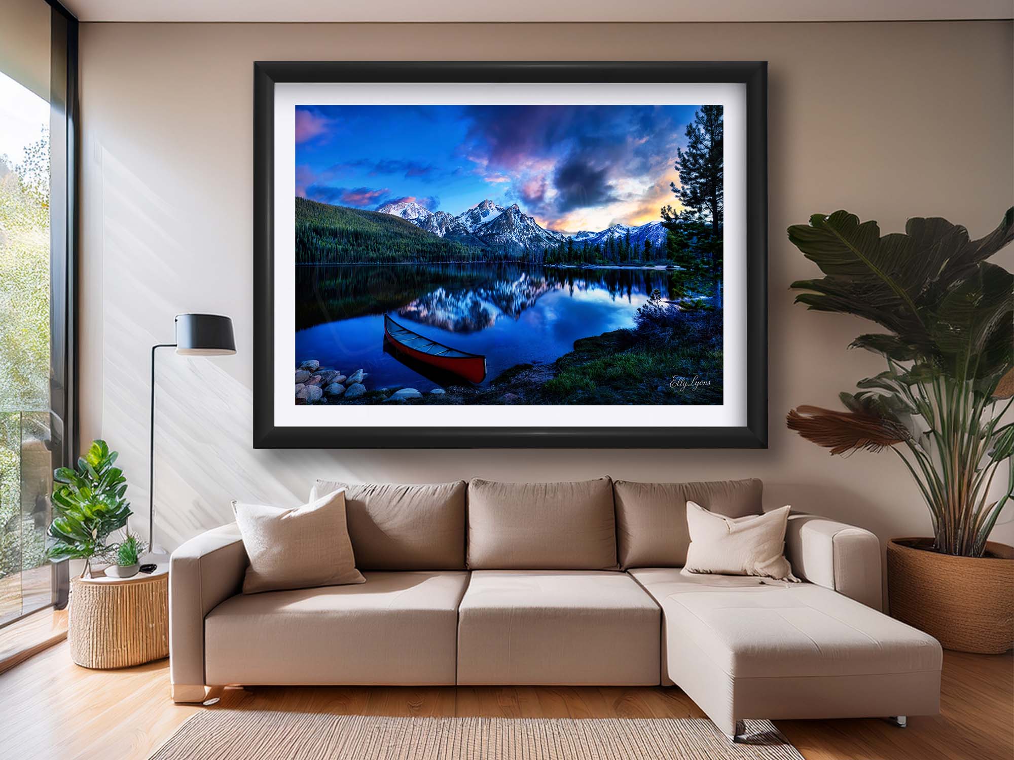 Sawtooth mountains at Stanley Lake in Idaho at sunset fine art print in black frame styled above a sofa in a bright living room