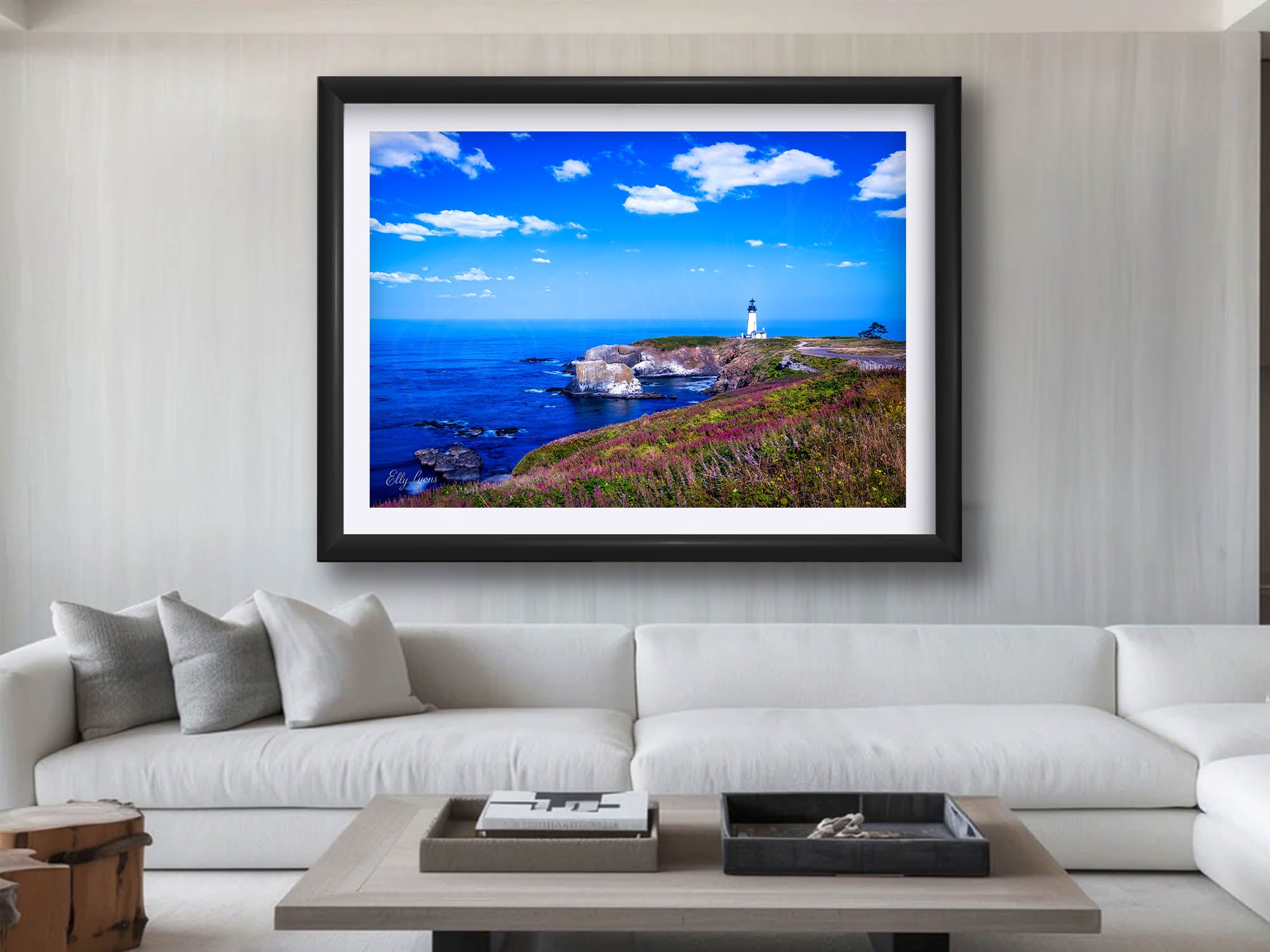 Yaquina lighthouse on the Oregon Coast fine art print in black frame styled above a sofa in a bright living room