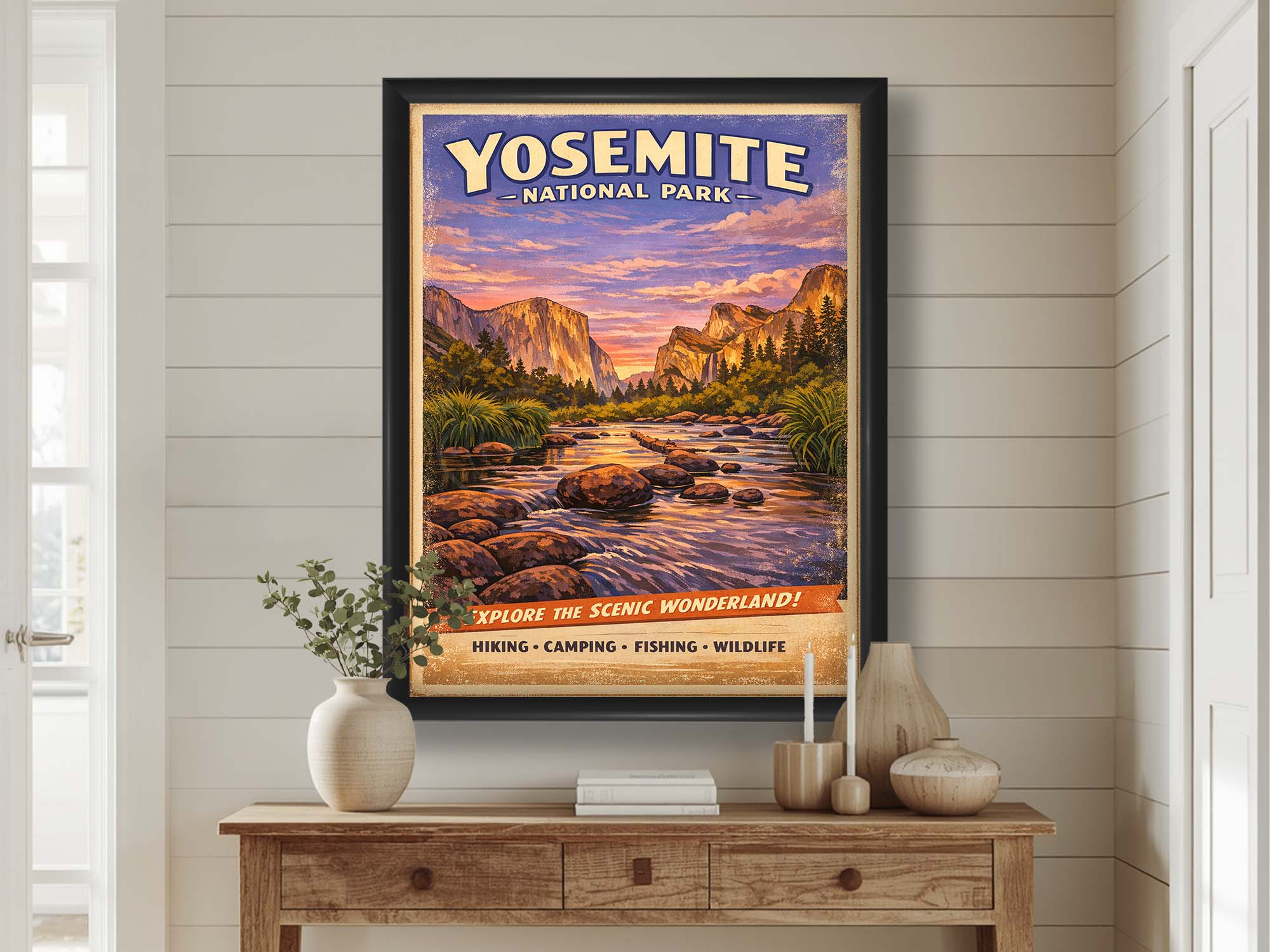 Yosemite National Park vintage travel poster featuring El Capitan and the Merced River in black frame styled above a wooden table in a bright entryway